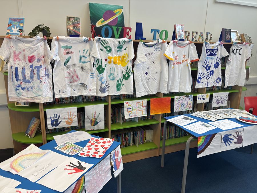 Hand-printed t-shirts displayed in a school library